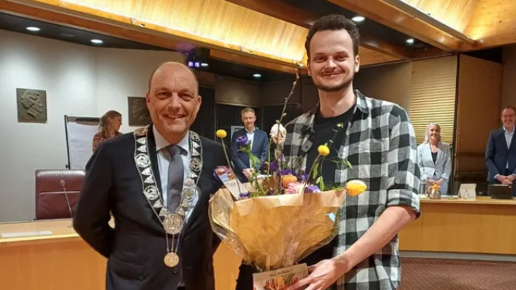 Burgerraadslid Stan Vergeer krijgt een bos bloemen van burgemeester Snijders