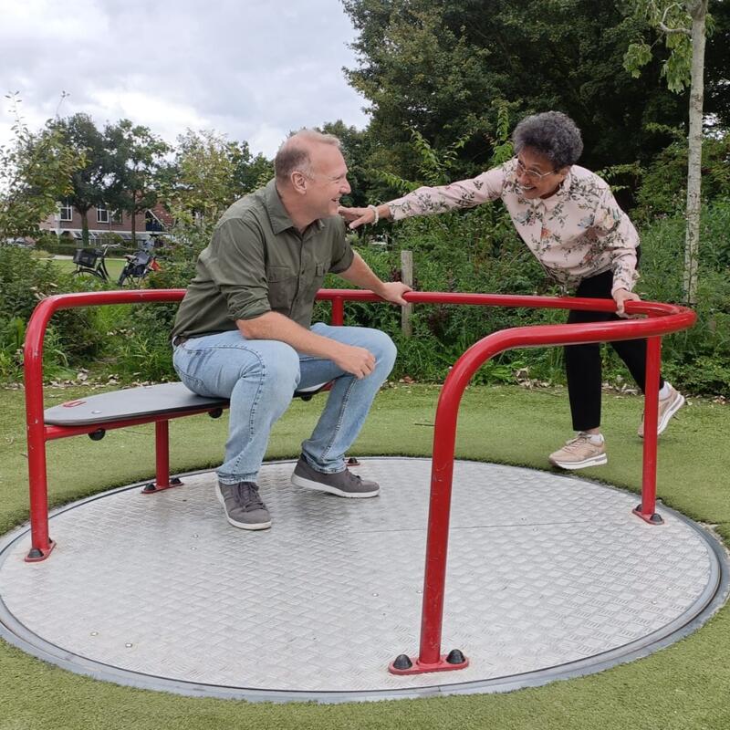 Patrick en Margriet bij een rolstoeltoegankelijke draaimolen